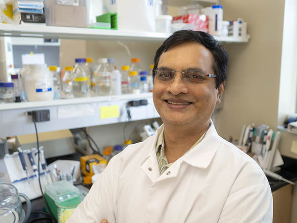 Posed image of Kiran Mysore in his laboratory.