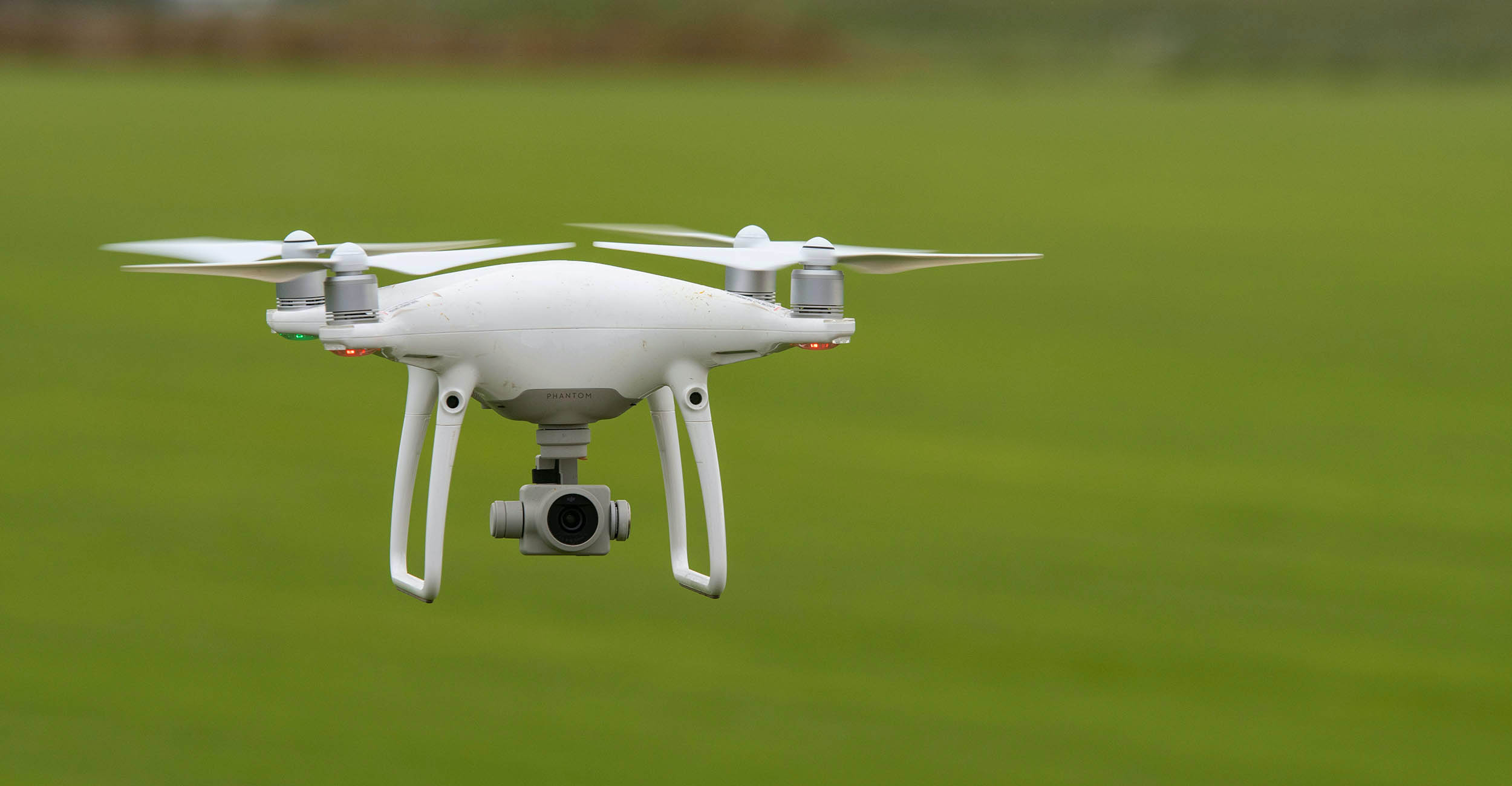 Drone in mid-air over an agricultural crop.