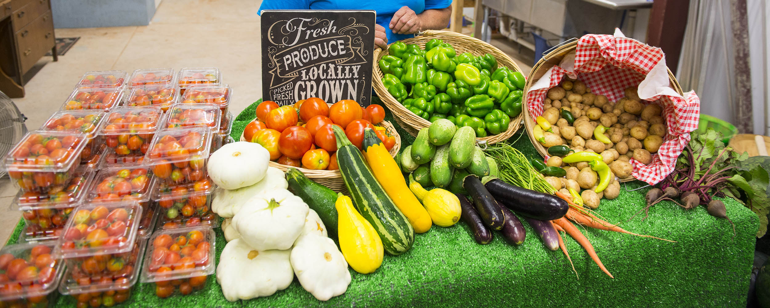 2025-grocersurvey-banner-1300x1000.jpg Produce laid out on a table at a farmer's market.